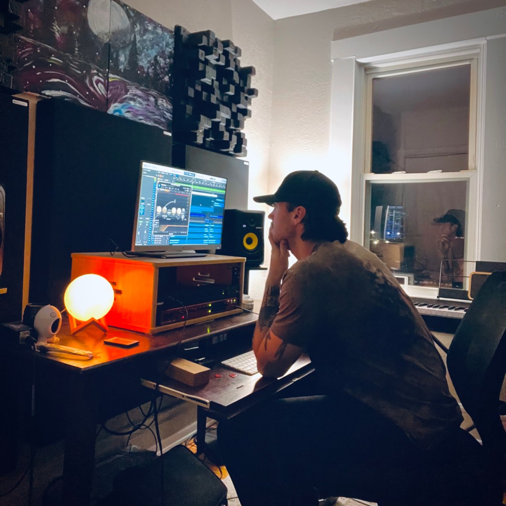 Dom pensively working in front of his home studio computer in this totally candid shot